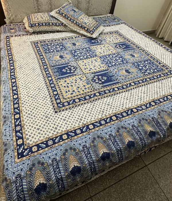 a bed with a blue and white bedding